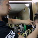 AT student Dricx Catap cuts a client's hair