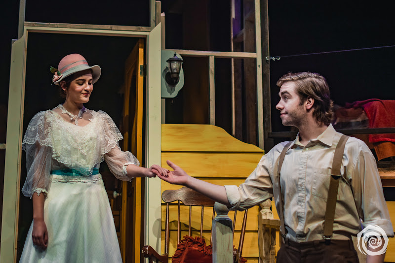 Two actors holding hands on stage during a production of Look Homeward, Angel.