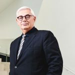 David Barnard stands at the bottom of a flight of stairs.