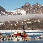 Ships and motor boats at an Arctic harbour