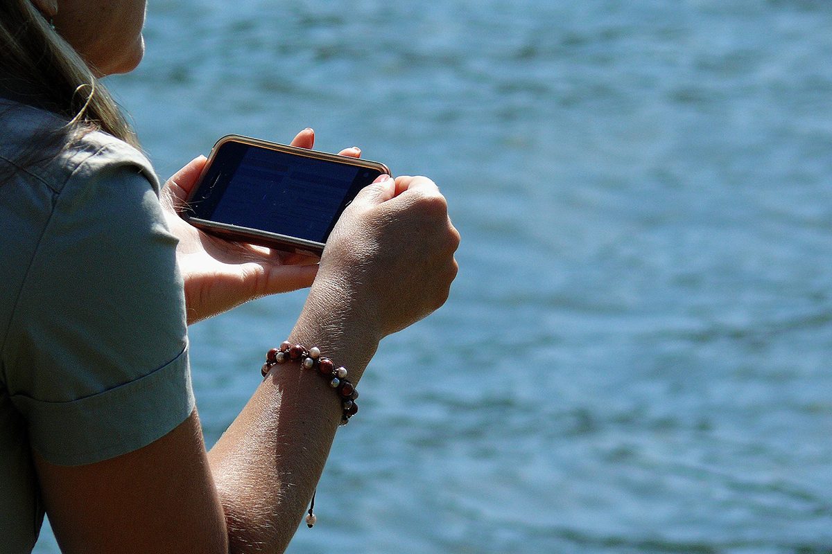 Woman holding cellphone. // Image from Pixabay.