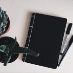 Plants and notebook on desk