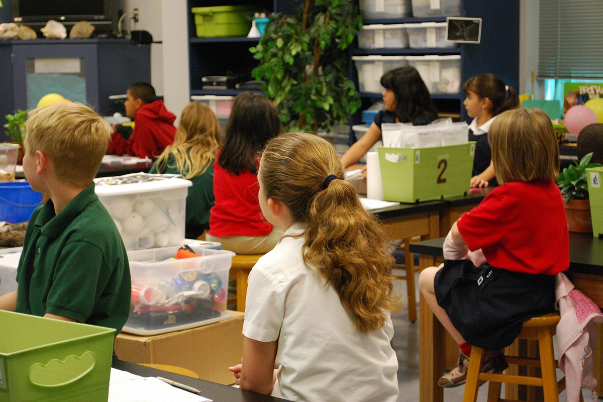 Children sitting in a classroom.