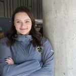 Deanna Pesun in the ALC Agora. She's wearing a U of M Bisons jacket.