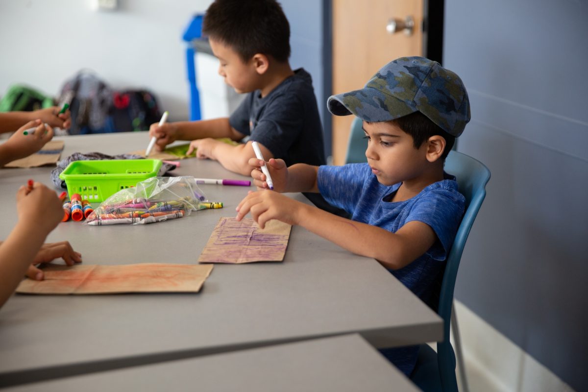 Child doing arts and crafts at Mini U