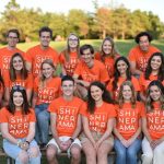 Group of students in orange shirts