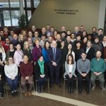 A group photo of more than 40 Asper School of Business. It is a diverse group of people and everyone is smiling.