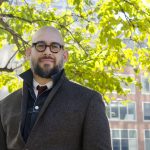 UM alumnus Dr. Carlos Quinonez stands outside at the University of Toronto, where he is a faculty member.