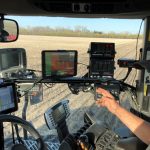 digital agriculture equipment in a truck with operator on a field of crops