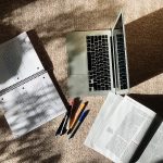 laptop and notebook on the floor