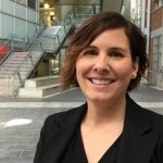 Kathryn Atamanchuk stands in the engineering information technology complex atrium posing for the camera