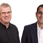 Picture of two smiling Asper professors.