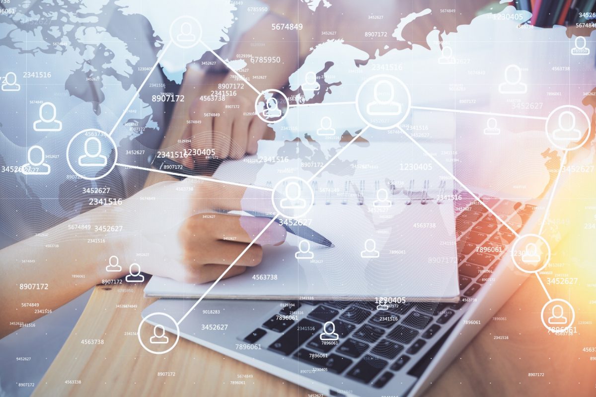 Image of hand and paper on a computer.