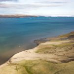 Thaw slumps are also a sign of the permafrost warming. These can be seen just barely in the satellite image as small dark regions along cliff faces, both facing the ocean and within the river drainage basins. Erosion and slumping expose ancient organic carbon to the air and the hydrosphere, thus providing an extensive positive feedback to climate warming.