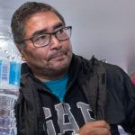 A water bottle sits on the table in front of Chief and NDP candidate Rudy Turtle during a visit by NDP Leader Jagmeet Singh on Oct. 5, 2019 on the Grassy Narrows First Nation, where industrial mercury poisoning in its water system has seriously affected the health of the community. // THE CANADIAN PRESS/Paul Chiasson