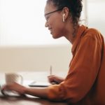 Woman having online meeting with colleagues on a video call working from home by Jacob Lund from Noun Project