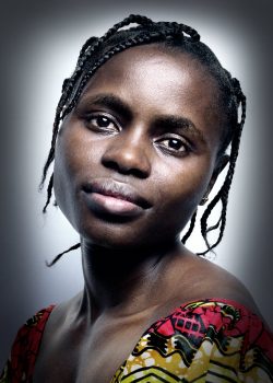 A headshot of Sandra, head tilted slightly to the side as she looks at the camera.