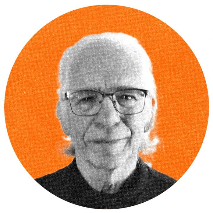 A headshot of Howard, wearing a black shirt and his glasses.