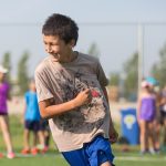 boy pictured playing outdoors at camp