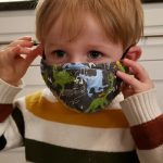 A child wears a face mask.