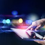person using tablet surfing internet with futuristic background