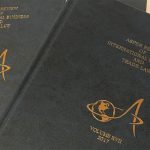 A number of books piled on top of each other.