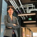Dean Marcia Friesen stands posing and smiling for the camera.