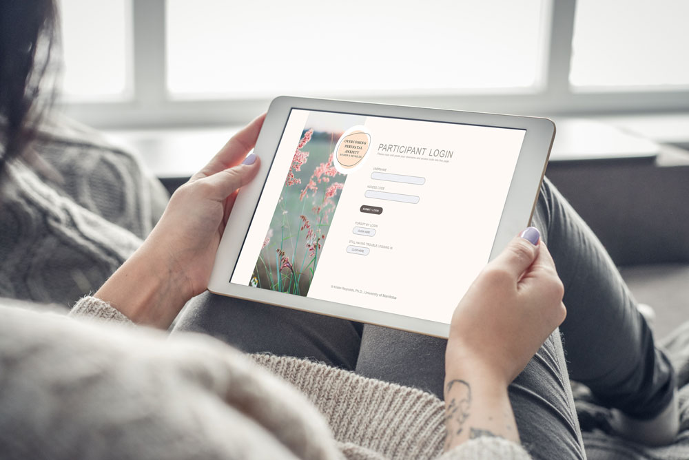 A person reads the UM website on a tablet computer