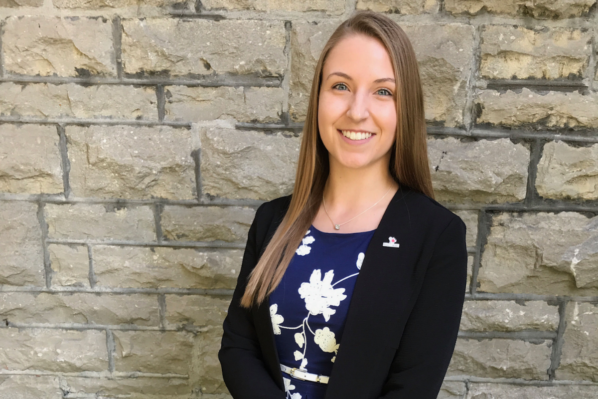 Lauren Slegers standing in front of a brick wall.