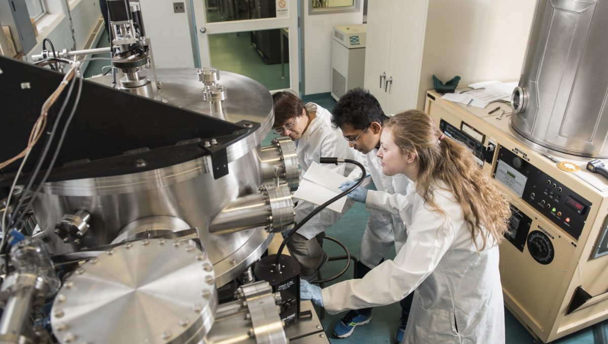 Students operating specialized microscopy equipment in NanoFab Laboraotry
