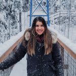 Taylor Antonchuck Emerging Leader Award recipient Faculty of Law smiling in winter on a suspension bridge.