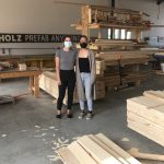 Two co-op students stand in a workshop.