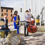Desautels Faculty of Music students Josh Bonneteau (drums), Joyce German (saxophone) and Sam Fournier (bass) perform on the future concert hall site.