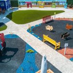 A children's play park designed with mini roads and traffic signs to teach road safety to young kids.