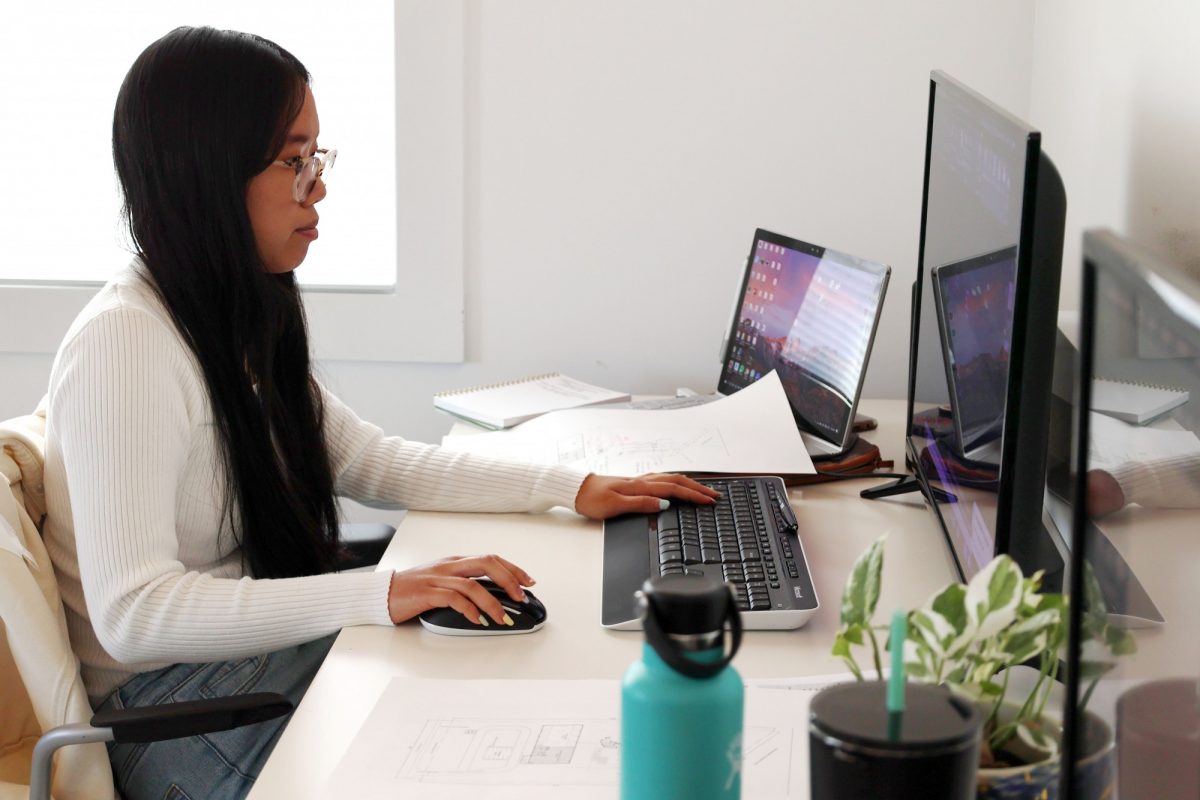 Carmen Huang sits working at desk.