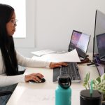 Carmen Huang sits working at desk.