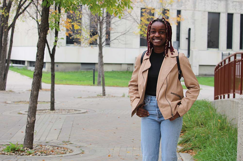 Student Chioma Nwagbo outside the Helen Glass Centre for Nursing at Fort Garry campus.