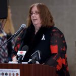 Ruth Eden stands at a podium speaking during the 2019 ecole polytechnique memorial service.