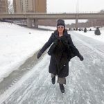 Asper School of Business alumna, Sara Stasiuk, walking on The Forks river trail, smiling.