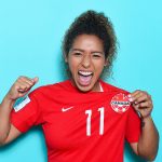 Desiree Scott poses proudly and shows off the logo on her shirt.