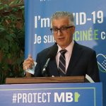 Michael Benarroch speaks at a lectern.