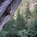 student climbing on side of mountain