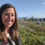Asper M B A student, Jessica Burtnick, smiling with the green Churchill tundra behind her.