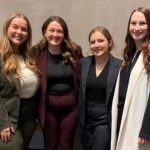 Four mini moot competition winners standing together.