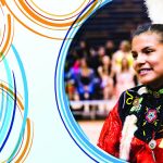 An Indigenous woman in regalia smiles