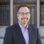 Greg Smith standing in front of Tier building