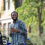 An international student standing outside on campus.