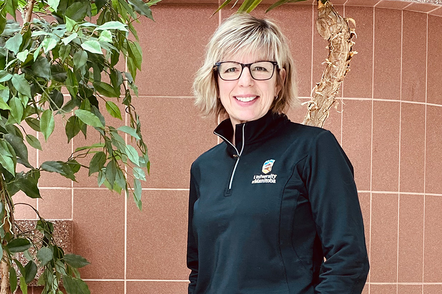 Kerri Chase smiles, wearing a black long sleeve