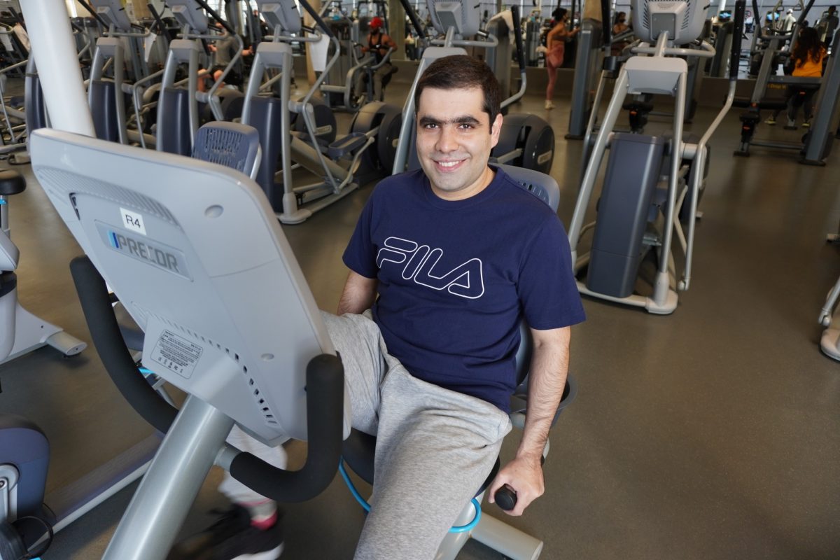 Saman Sobhani sits on a workout bike