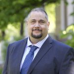 Headshot of Dr. Richard Jochelson, Dean of the Faculty of Law, UM in front of Robson Hall